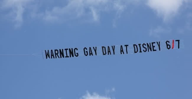 INDECENCY AT DISNEY PARKS: Banners like this one have been flown over Disney World by the Florida Family Association in recent years--leading to a reduction of normal families visiting the Magic Kingdom theme park that day. We altered the date for this year (2014) to Saturday, June 7--which is when the massive "Gay Days" celebration is scheduled for Magic Kingdom (See entire "Gay Days 2014" schedule for June 3-9 above or go HERE.) For years, Pete Werner, an openly homosexual Disney travel expert (and "gay rights" advocate), has been warning parents not to bring their children to Disney World's various theme parks on the respective days targeted for "Gay Days"--due to the excessive homosexual PDAs (public displays of affection) and homo-erotic flaunting that goes on there, much of it aimed at scandalizing families and kids. Disney officials do not warn families in advance that their parks will be inundated by "Gay Days" celebrants--so every year outraged parents who arriving unknowingly on that date demand their money back.